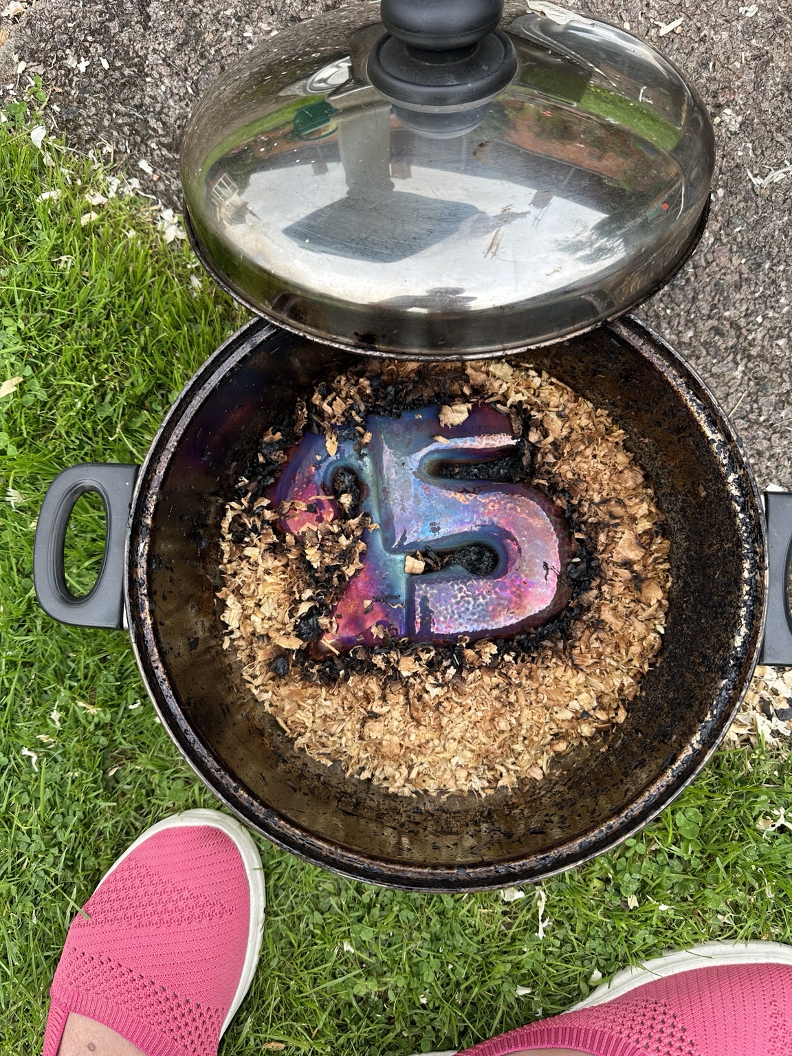 A freshly fired Raku piece resting in combustible material